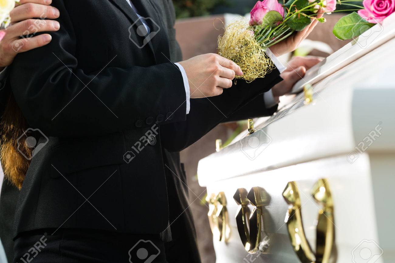 Persona consolando a otra en funeral