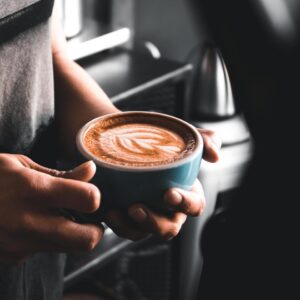 person holding cup of coffee free photo